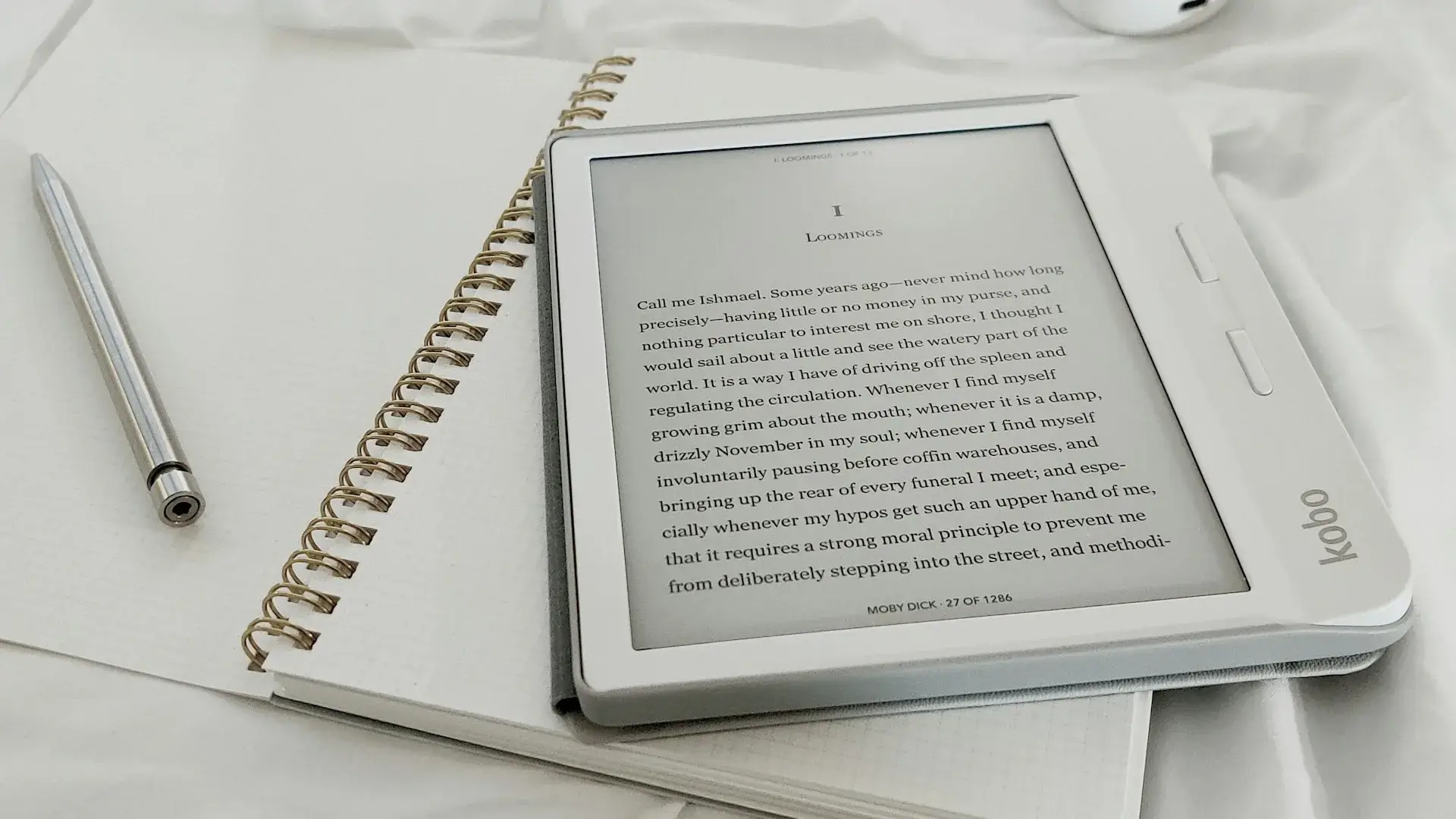 Kobo e-reader resting on a notebook — sell ebooks directly to readers from your author website